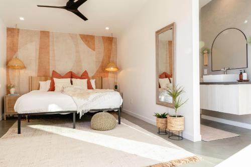 a bedroom with a large bed and a sink at Ventana Cove Pickleball Retreat in Yucca Valley