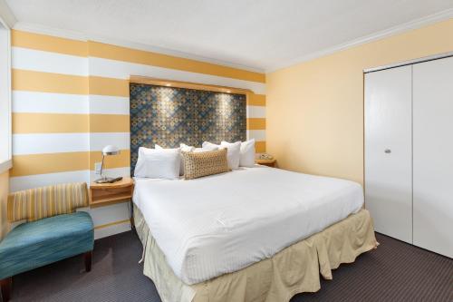a hotel room with a bed and a chair at Pan American Oceanfront Hotel in Wildwood Crest