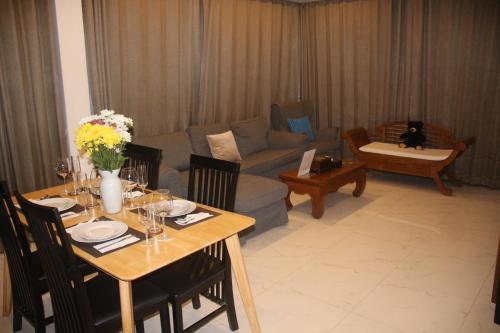 a living room with a table and a couch at Chic Villa 6 in Chiang Mai