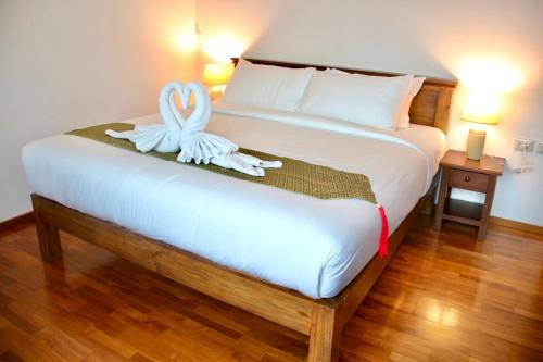 a bedroom with a bed with two towels on it at Chic Villa 6 in Chiang Mai