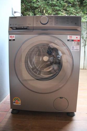 a washing machine with its door open in a room at Chic Villa 6 in Chiang Mai