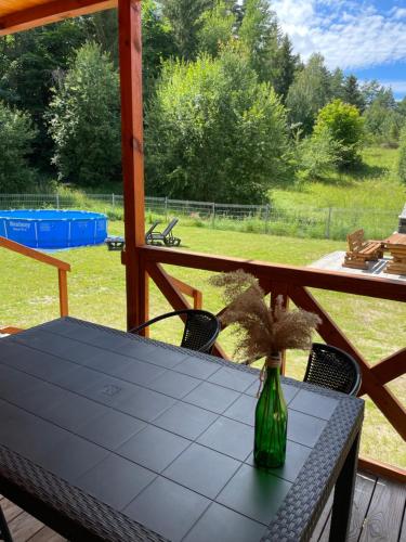 a table with a vase with a plant on it at Słoneczne wzgórze domki pod lasem in Swieszyno