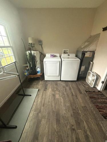 a laundry room with a washer and dryer at Quaint cottage near Local and State Parks and Minutes from Laurel Cove and Bell Theatre in Pineville