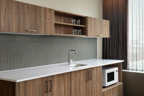 a kitchen with a sink and a microwave at AC Hotel Detroit at the Bonstelle in Detroit