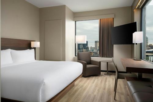 a hotel room with a bed and a desk at AC Hotel Detroit at the Bonstelle in Detroit