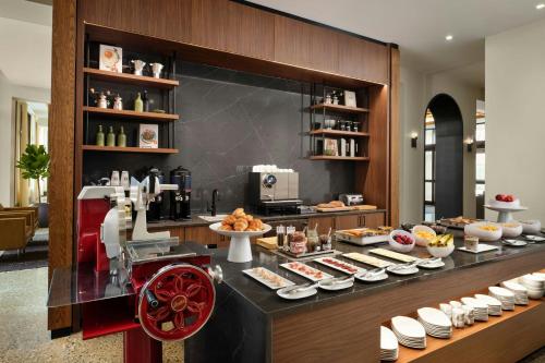 a buffet line with food on display in a restaurant at AC Hotel Detroit at the Bonstelle in Detroit