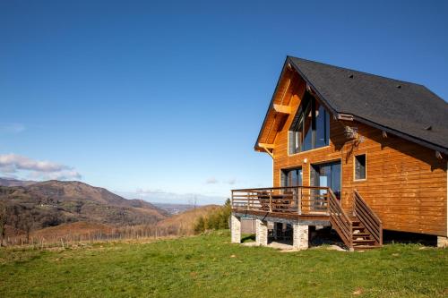 a wooden house on top of a hill at Chalet dans les Hautes- Pyrénées entre Lourdes et Bagnères Calme et Vue magnifique in Arrodets-ez-Angles