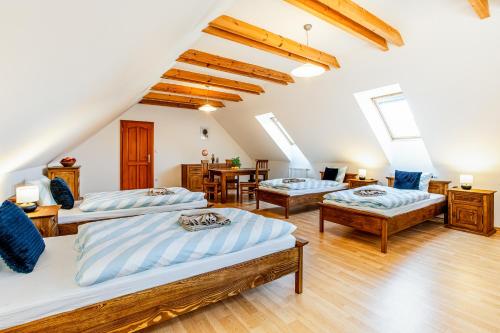 a room with three beds and a table at Ubytování Halámky 38 in Halámky