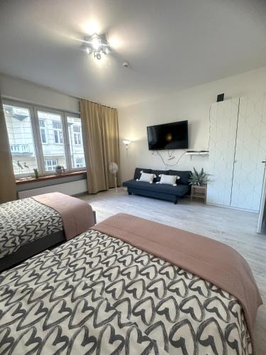 a large bedroom with a bed and a couch at Exclusive Apartments Smolna in Warsaw