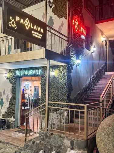 a building with a staircase on the side of it at Paxlava Dilijan Guesthouse & Restaurant in Dilijan