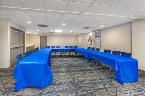 a conference room with blue tables and chairs at Holiday Inn Express Crestwood by IHG in Crestwood