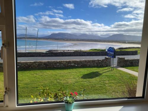 a view of a beach from a window at Seacrest Guesthouse in Mullaghmore