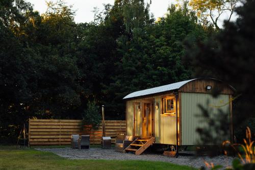 a small shed sitting in the middle of a yard at Cwtch Ffynnone Luxury Shepherds Hut in Newchapel