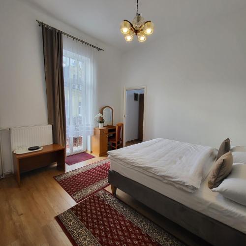 a bedroom with a large bed and a large window at Pałacyk Srebrna Fala in Międzyzdroje