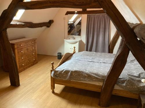 a bedroom with a wooden bed and a dresser at Oud-Bommerich in Mechelen
