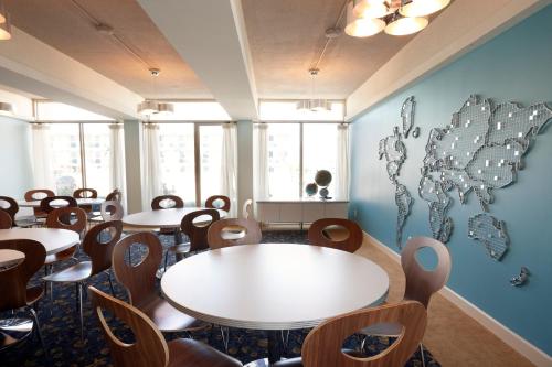 a restaurant with tables and chairs in a room at Pan American Oceanfront Hotel in Wildwood Crest