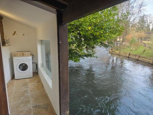 a house with a view of a river at Maison Normande bord de rivière in Saint-Denis-le-Ferment