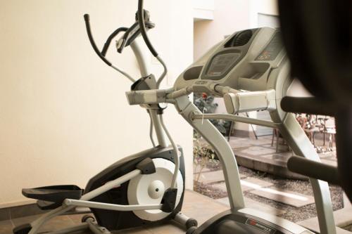 a exercise bike in a gym with a treadmill at Rincon del Valle Hotel & Suites in San José