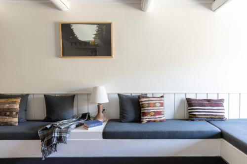 a room with two beds with blue cushions at Scribner's Catskill Lodge, a Member of Design Hotels in Hunter