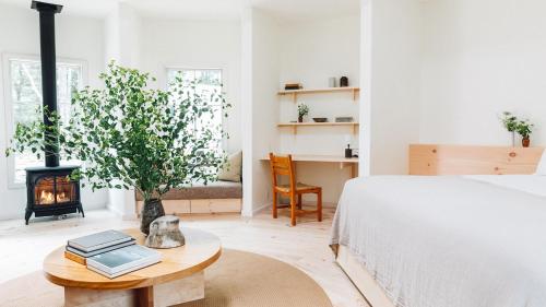 a bedroom with a bed and a fireplace at Scribner's Catskill Lodge, a Member of Design Hotels in Hunter