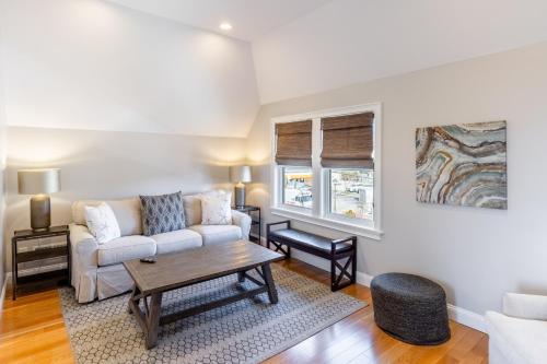 a living room with a couch and a table at The Newport Lofts - 595 Thames Street in Newport
