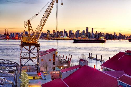 a view of a city skyline with a crane at Pinnacle Hotel at the Pier in North Vancouver