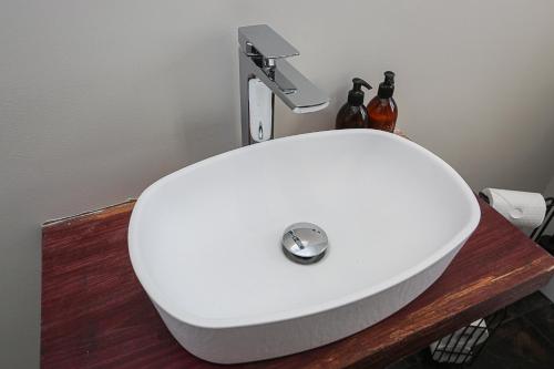 a white sink sitting on top of a wooden table at Little Priory in Lisburn