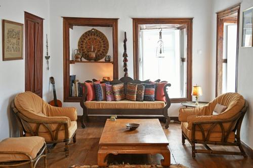 a living room with a couch and two chairs at Serendipity Home in Hydra
