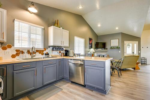a kitchen with blue cabinets and a counter top at Deck and Mountain Views Cedar City Family Home! in Cedar City