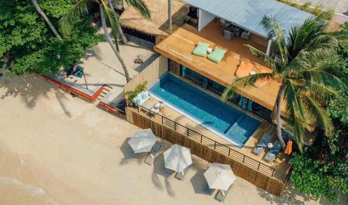 an overhead view of a house with a swimming pool at Sea&Sky Beach Resort Beachfront Bungalows & Pool Villas in Mae Nam