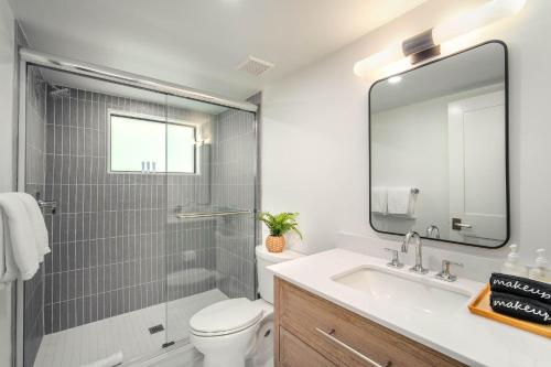 a bathroom with a sink and a toilet and a mirror at Pines & Palms Resort in Islamorada