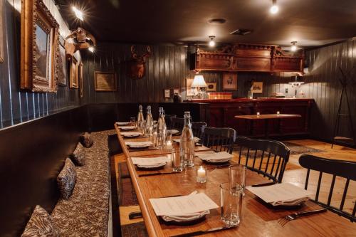 a dining room with a long table and chairs at Scribner's Catskill Lodge, a Member of Design Hotels in Hunter