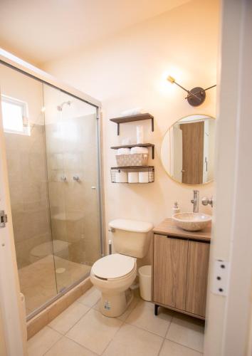 a bathroom with a shower and a toilet and a sink at Departamento Nuevo en Hermosillo in Hermosillo