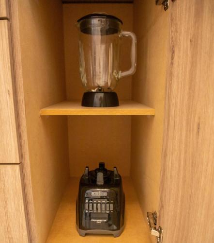 a blender sitting on a shelf in a cupboard at Departamento Nuevo en Hermosillo in Hermosillo