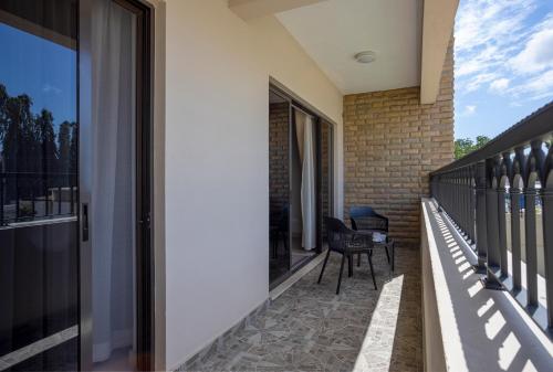 a balcony with a table and a chair at Marjaan Apartments in Mombasa
