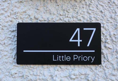 a sign on a wall that reads little priority at Little Priory in Lisburn