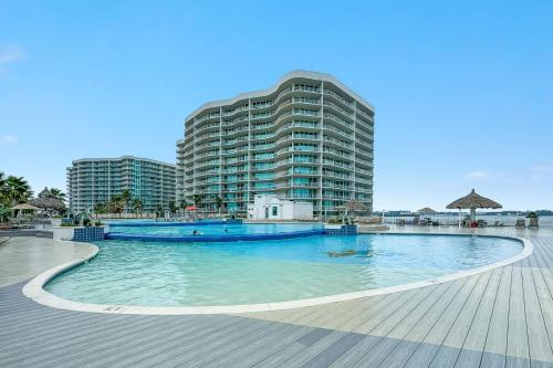 a large swimming pool in front of a large building at Caribe D-0404 in Orange Beach