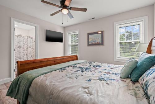 a bedroom with a bed and a ceiling fan at Tranquility - Brand new home in quiet location! in Deep Hole