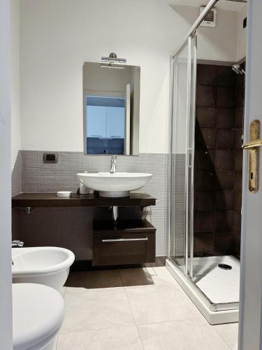 a bathroom with a sink and a toilet and a shower at Stella Toscana Apartments in Forte dei Marmi