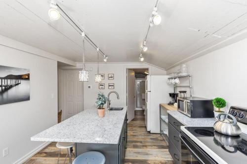 a kitchen with white walls and a counter top at Hummingbird in Saugatuck