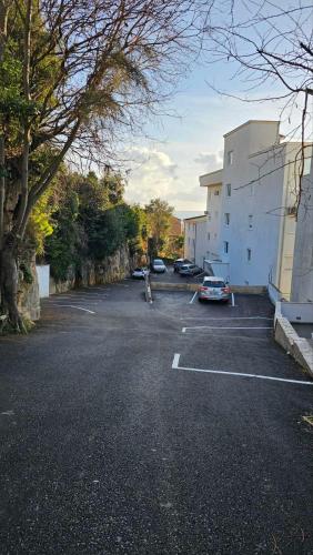 a parking lot with cars parked next to a building at Monte View Apartments in Ulcinj
