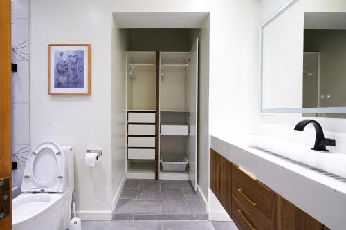 a bathroom with a toilet and a sink at Modern Loft with Park Like Setting View in Kirkland