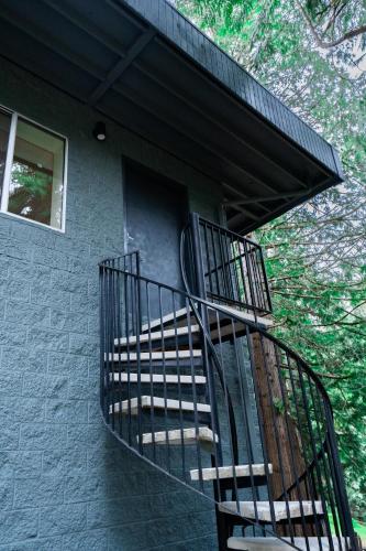 a spiral staircase on a building with a window at Modern Loft with Park Like Setting View in Kirkland