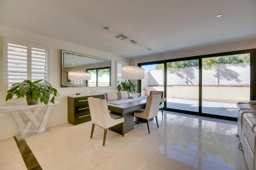 a kitchen and dining room with a table and chairs at Luxurious and Spacious Family Duplex in Menifee! in Menifee