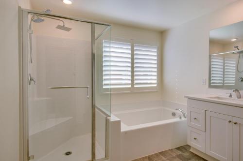 a white bathroom with a shower and a sink at Luxurious and Spacious Family Duplex in Menifee! in Menifee