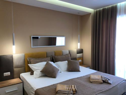 a bedroom with a bed with a television above it at Fabio Apartment Qerret in Golem