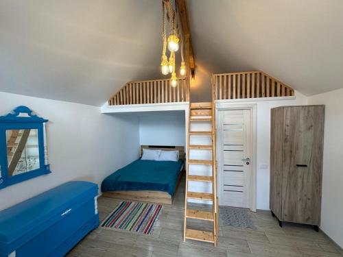 a bedroom with two bunk beds and a ladder at La Casute in Jurilovca