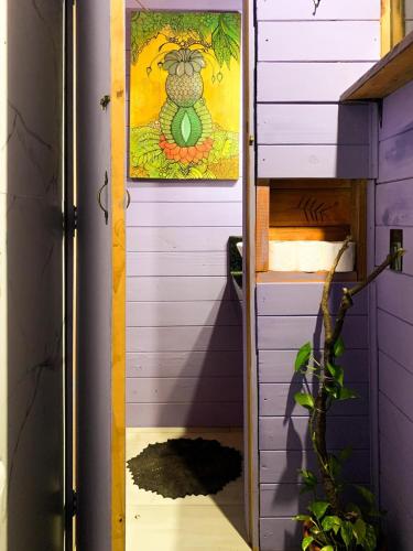 a door to a house with a painting on the wall at Cabana Urbana in Cascavel