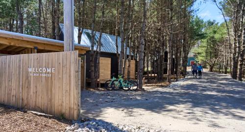 a building with a bike parked in front of it at Black Forest Cabins in Mahone Bay