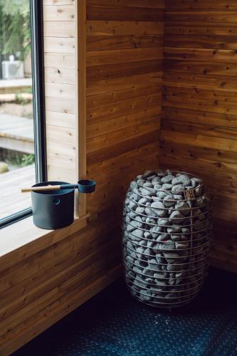 a corner of a sauna with a plant sitting next to a window at Black Forest Cabins in Mahone Bay